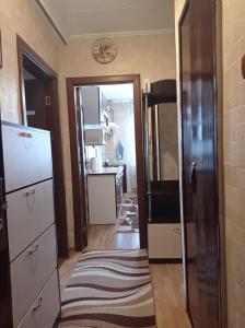 a kitchen with a door open to a kitchen with a refrigerator at Apartament Anastasia.Plaja Modern in Constanţa