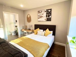 a bedroom with a large bed with a yellow blanket at 303 Cozy and modern 1BR apartment in center City in Philadelphia