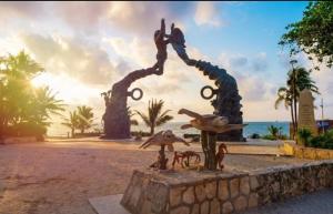 a statue on the beach near the ocean at Caribe Grand Dream in Playa del Carmen