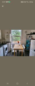 a kitchen with a table and a kitchen with a window at Quiet Room Near Arsenal Stadium Islington Zone 2 Cental in London