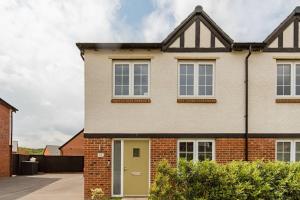 a brick house with a yellow door at Private Double bedroom in Thringstone