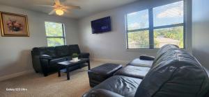 a living room with a leather couch and a table at Apartment in Ponte Vedra Beach in Ponte Vedra Beach