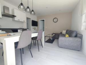 a living room with a table and chairs and a couch at Garden in Sutomišćica