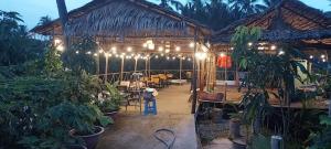 a restaurant with a bunch of plants and lights at Room in Vietnam 1 in Ben Tre