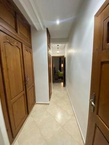 a hallway with a wooden door and a hallway with a room at Super et magnifique Appartement. in Safi