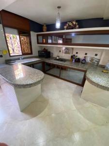 a kitchen with granite counter tops in a room at Super et magnifique Appartement. in Safi