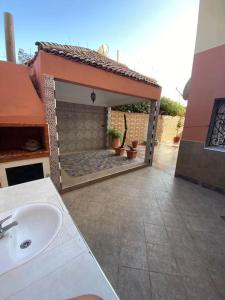 a bathroom with a sink and a patio with a fireplace at Super et magnifique Appartement. in Safi
