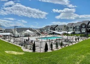 a pool at a apartment complex with houses at NEW 4-bed 4-bath Stylish House with Mountain View and 2 garages in Lehi