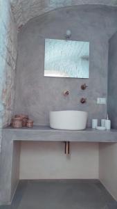 a bathroom with a white sink on a counter at Scardino Trulli in Locorotondo