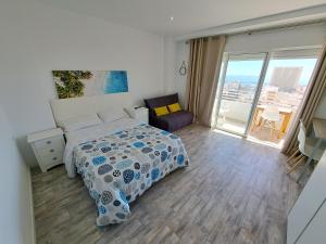 a bedroom with a bed and a view of the city at Mirador 22 in Alicante