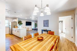 a dining room and kitchen with a wooden table and chairs at The Jewel of Elkhart, Upper Unit in Elkhart