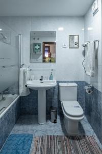a bathroom with a sink and a toilet and a mirror at AguasBlancas VUT LE 446 in La Pola de Gordón