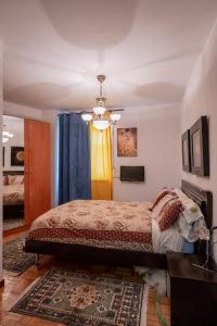 a bedroom with a bed and a chandelier at AguasBlancas VUT LE 446 in La Pola de Gordón