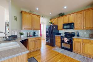 a kitchen with wooden cabinets and black appliances at It's Always Sunny in Sykesville in Sykesville
