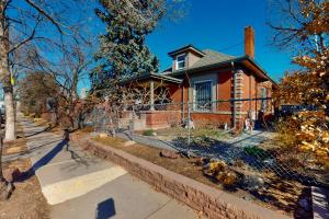 a brick house with a fence in front of it at Elati Guesthouse in Denver