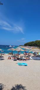 a group of people laying on a beach at Harizma in Primošten