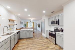 a kitchen with white cabinets and a counter top at The Modern Farmhouse Cottage in Wichita Falls