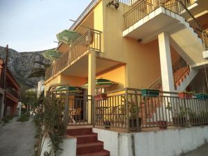 een gebouw met trappen en balkons met een berg op de achtergrond bij Vito Apartments Sutomore in Sutomore