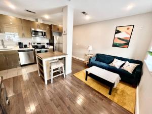 a living room with a blue couch and a kitchen at 307 Kyoto style 1BDR Apt in center city in Philadelphia