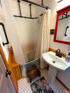 a bathroom with a sink and a shower at Kataluma Inn, Sandpoint, Idaho - entire cozy cabin in Sandpoint