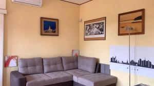 a living room with a couch in a room at Como Lake Milano Dream Apartment in Guanzate