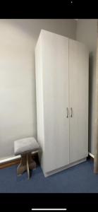 a white cabinet with a bench in a room at LOONA FAMILY HOSTEL in Tashkent