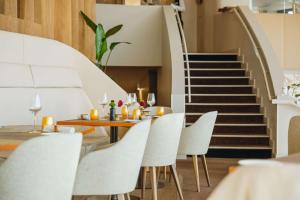 a dining room with a table and chairs and stairs at Radisson Blu Hotel, Lyon in Lyon