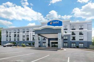 a building with a car parked in a parking lot at Comfort Inn & Suites Voorhees-Mt Laurel in Voorhees