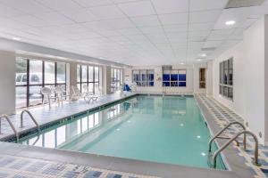 a large swimming pool with blue water in a building at Comfort Inn & Suites Voorhees-Mt Laurel in Voorhees