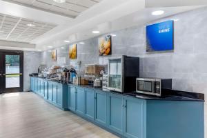 a cafeteria with a blue counter with microwaves at Comfort Inn & Suites Voorhees-Mt Laurel in Voorhees