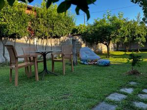 a yard with chairs and a table and a play equipment at Chateau Sukaj in Laknas