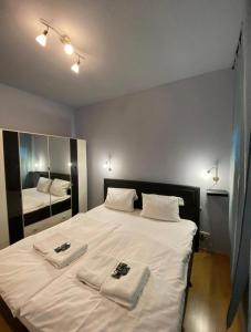 a bedroom with a white bed with towels on it at Zentraler Komforttraum in Berlin