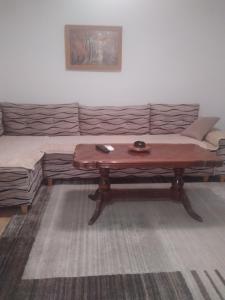 a living room with a coffee table and a couch at Apartman Perper 2 Trebinje in Trebinje