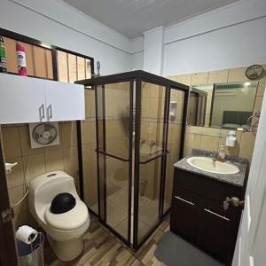 a bathroom with a shower and a toilet and a sink at La Esmeralda Villa in Orotina