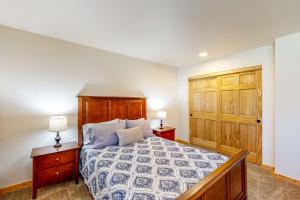 a bedroom with a bed with two night stands and two lamps at Marsh Hawk Cabin in Klamath Falls +28 photos