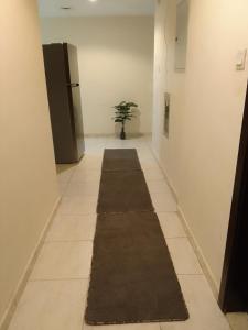 um corredor com um tapete longo no chão em شقه غرفتين مفروشه em Sharjah