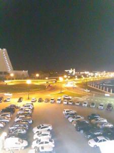 a parking lot filled with cars at night at شقه غرفتين مفروشه in Sharjah