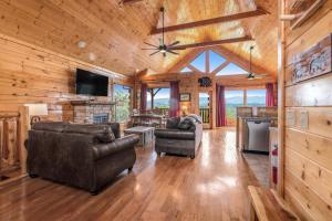 a living room with leather furniture and a flat screen tv at The Sweet Escape in Sevierville