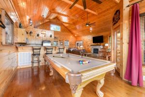 a pool table in a room with a kitchen at The Sweet Escape in Sevierville