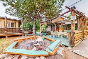 a house with a deck with a fire pit at Cedaredge Lodge, Cabin 3 in Cedaredge