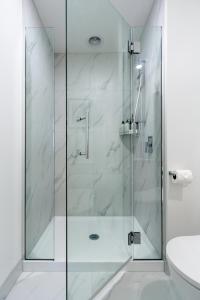 a shower with a glass door in a bathroom at 3 bedroom 2 bath Central City in Christchurch
