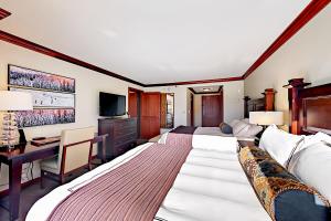 a hotel room with two beds and a desk at 556 Everline in Olympic Valley