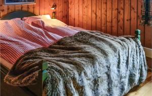 a bed with a blanket on top of it at Stunning Home In Beitostlen With 3 Bedrooms in Beitostøl