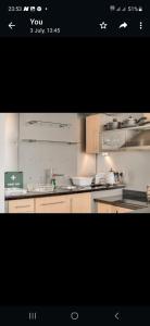 a kitchen with white cabinets and a counter top at Princess Street Apartment in Manchester