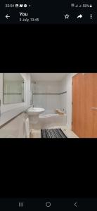 a bathroom with a white tub and a sink at Princess Street Apartment in Manchester