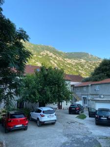 a group of cars parked in a parking lot at Goga Apartment in Kotor