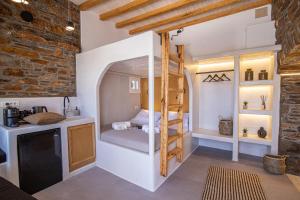 a small bedroom with a bunk bed in a room at KL , Cozy Suite II in Kithnos