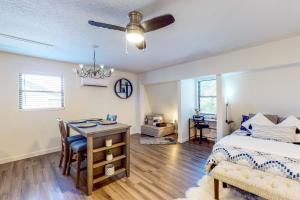 a bedroom with a bed and a desk and a table at Hop Top Rental in Orlando