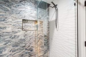 a shower with a glass door in a bathroom at Hop Top Rental in Orlando
