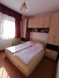 a bedroom with a large bed in a room at Anna Vendégház in Balatonőszöd